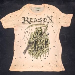 Small pink "reason" short sleeve graphic shirt with black polka dots.